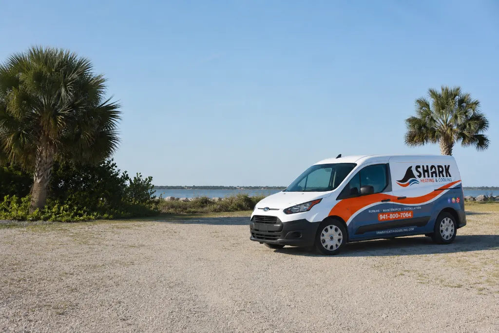 Shark Heating and Cooling service van parked beside the Southwest Florida waterfront